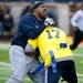 Blue Team player Gilvanni Johnson breaks up a pass intended for John Ferens during the alumni spring flag football game on Saturday, April 13. AnnArbor.com I Daniel Brenner